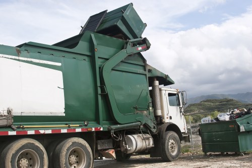 Commercial waste crew in Garston loading a van