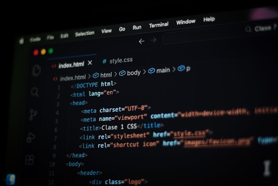 Photograph of a computer screen displaying lines of colorful programming code with syntax highlighting, including keywords, variables, functions, and symbols in shades of red, green, blue, yellow, and